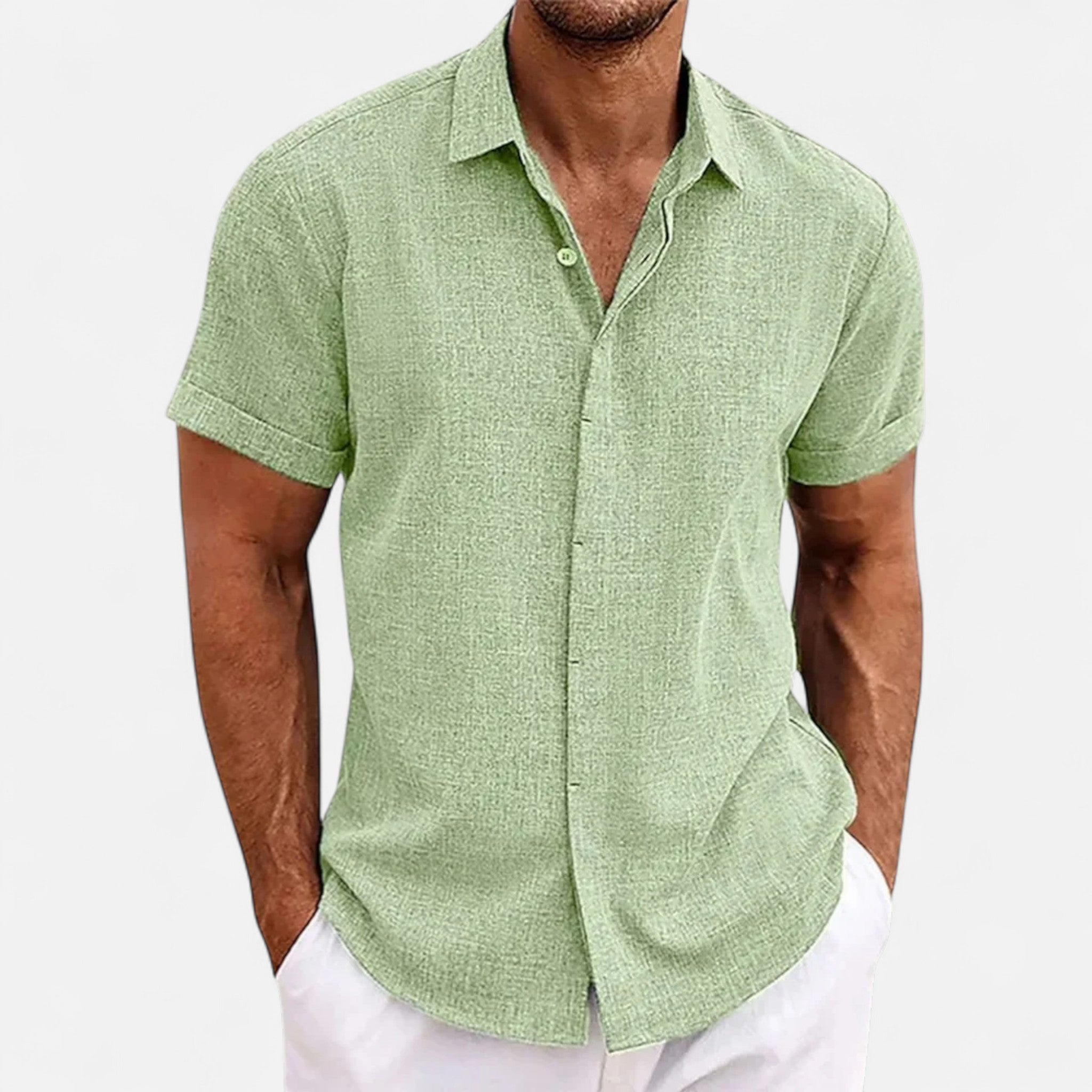 Man wearing a green short-sleeve shirt on a white background