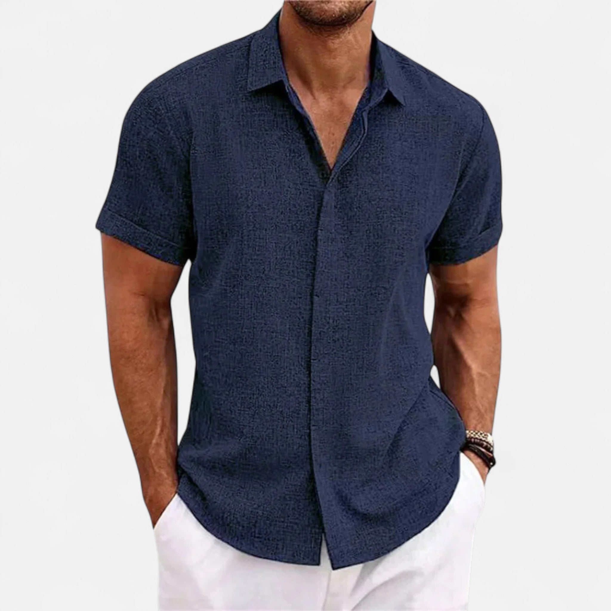 Man wearing a navy blue short-sleeve shirt on a white background