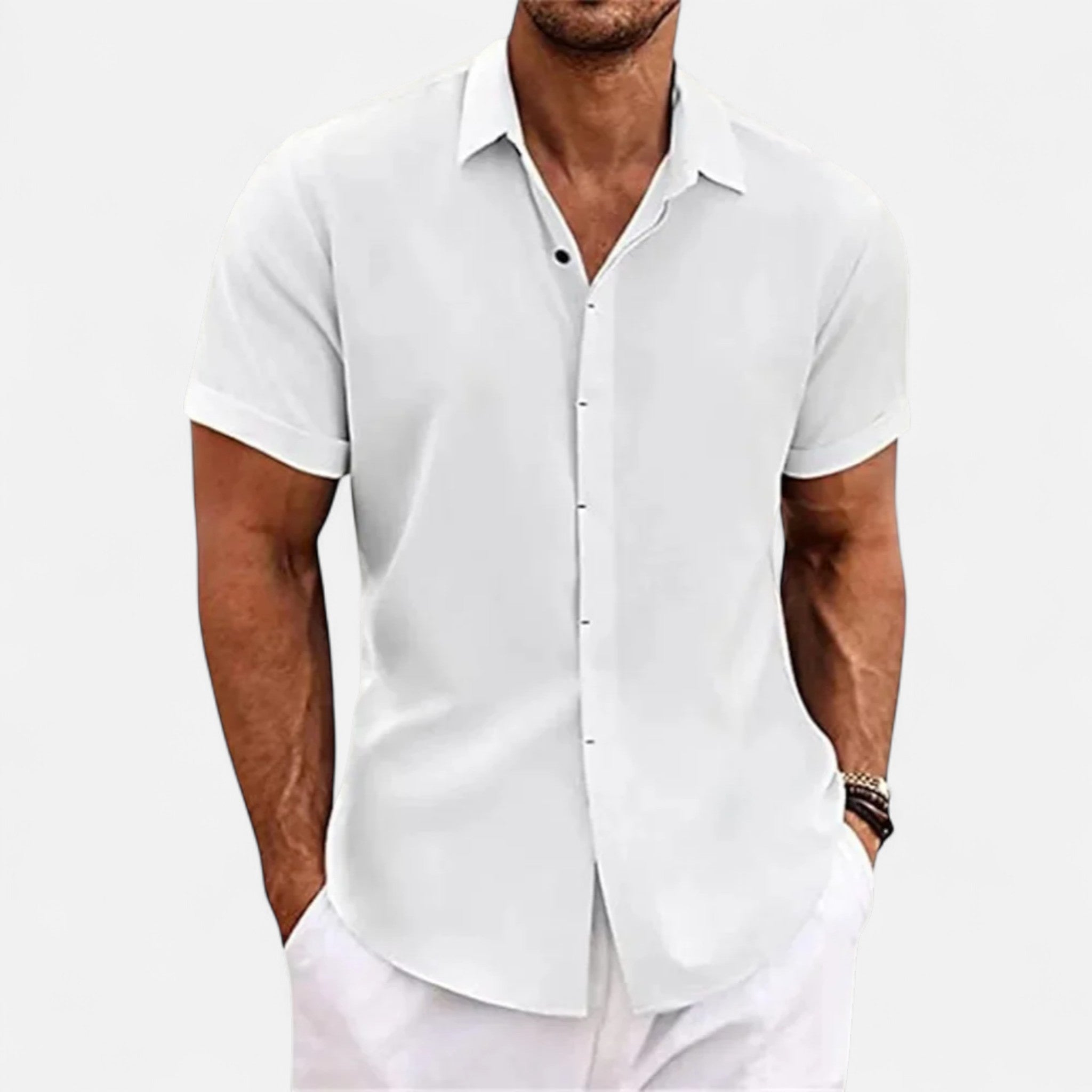 Man wearing a white short-sleeve shirt on a light gray background