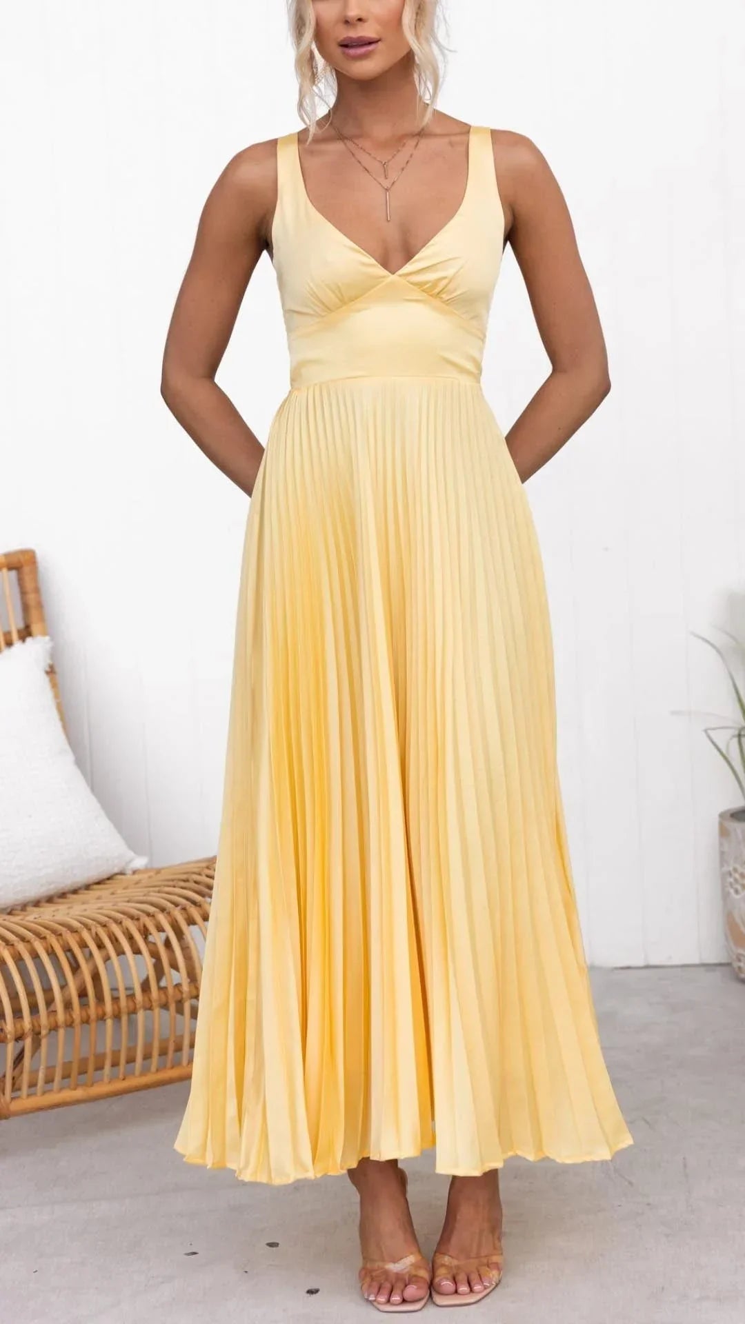 Woman wearing a yellow dress in a minimal indoor setting