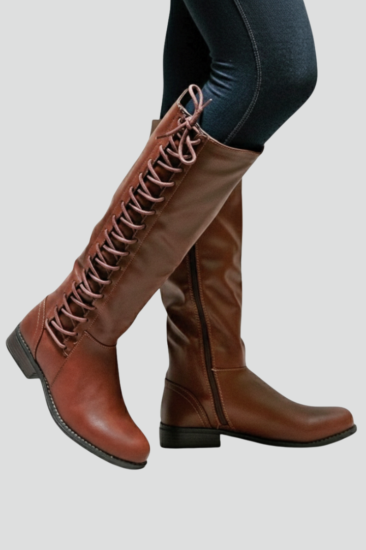 Brown knee-high boots with laces on a light gray background