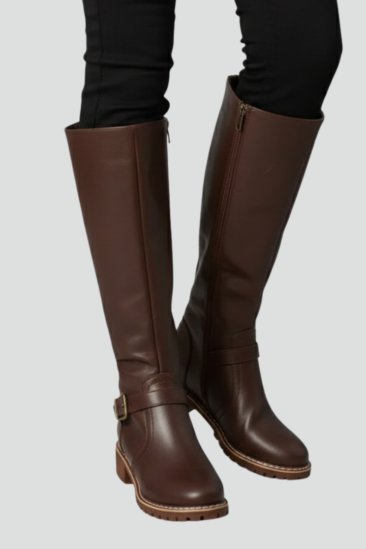 Brown knee-high boots on a plain background