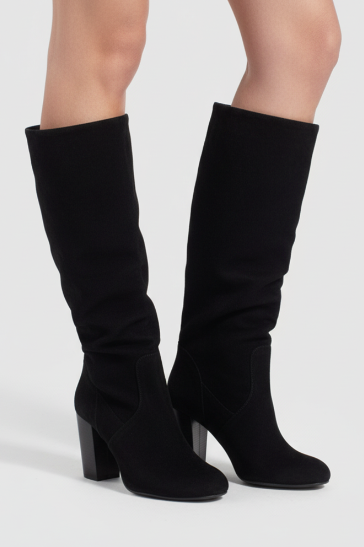 Black knee-high boots on a white background