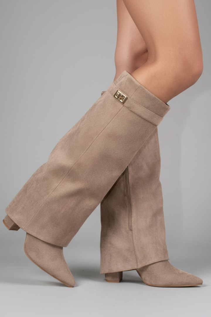 Beige suede gaiters worn by a person on a gray background