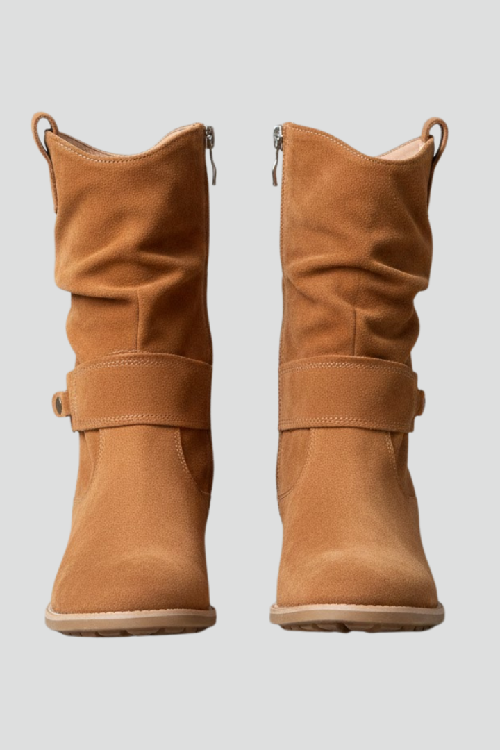 Pair of brown boots on a light gray background