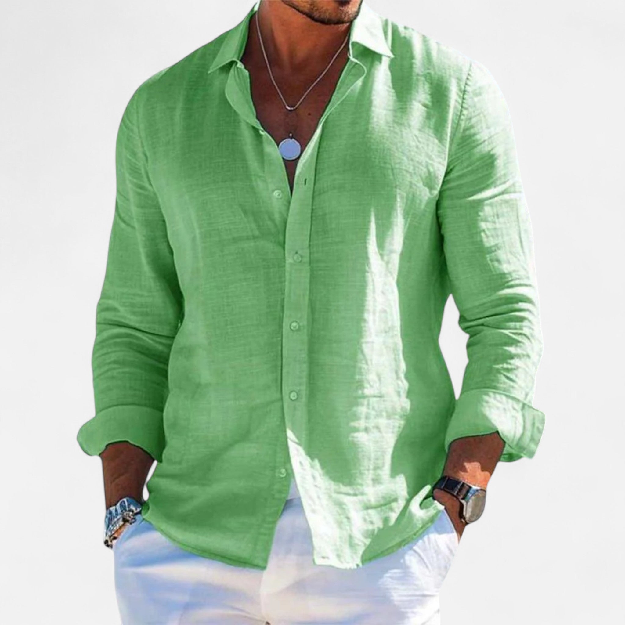 Person wearing a green linen shirt on a white background