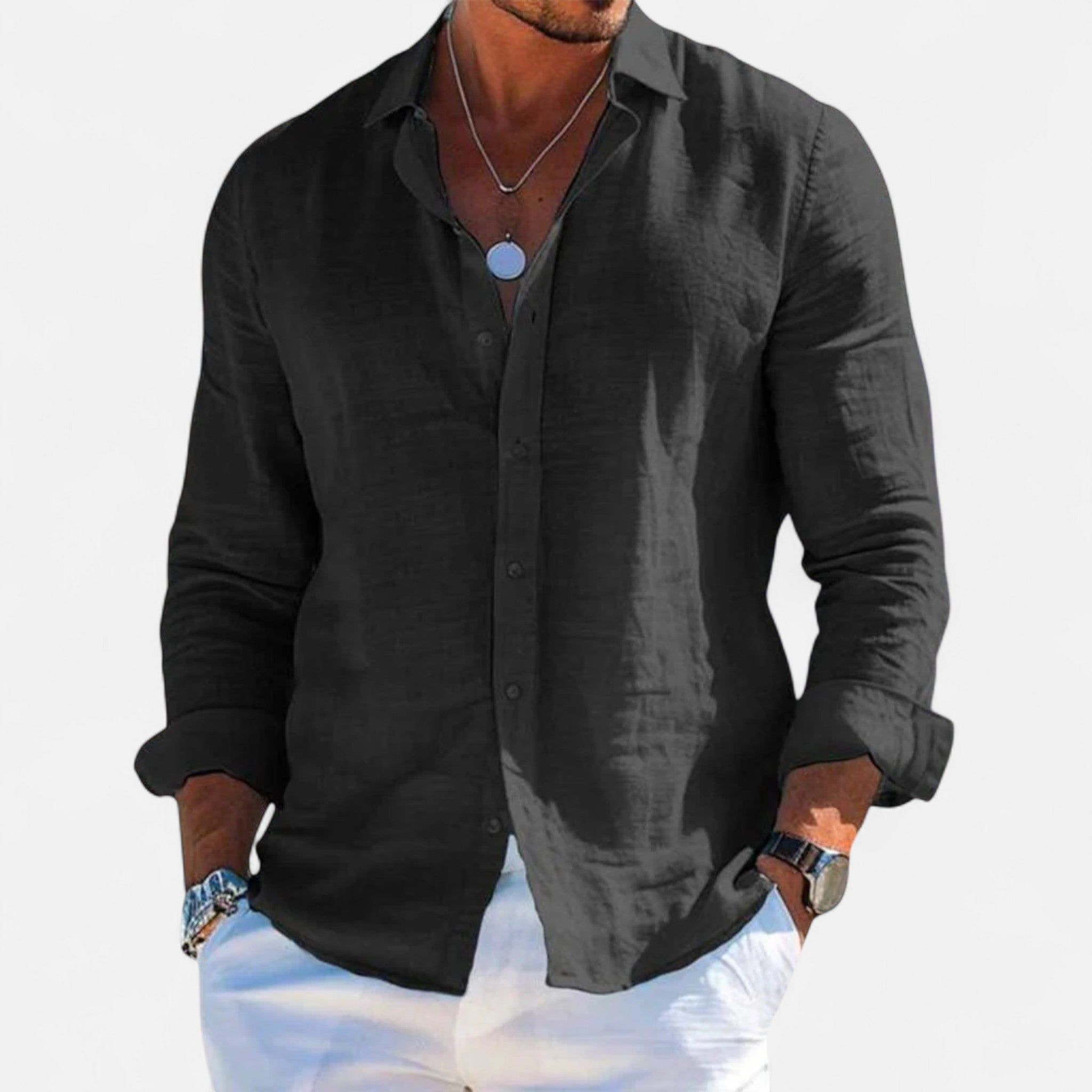 Black button-up shirt worn by a person on a white background