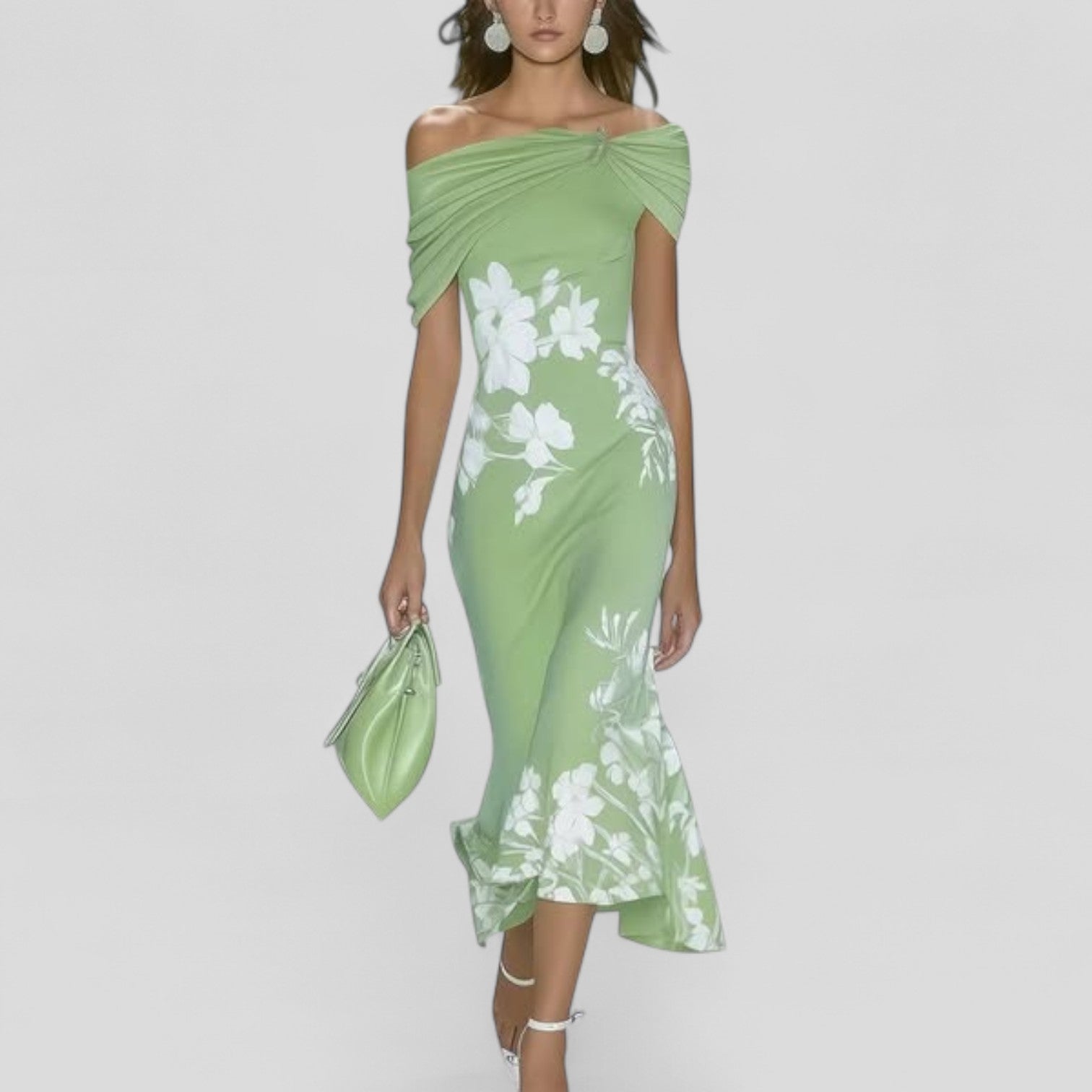 Woman wearing a green floral dress on a white background