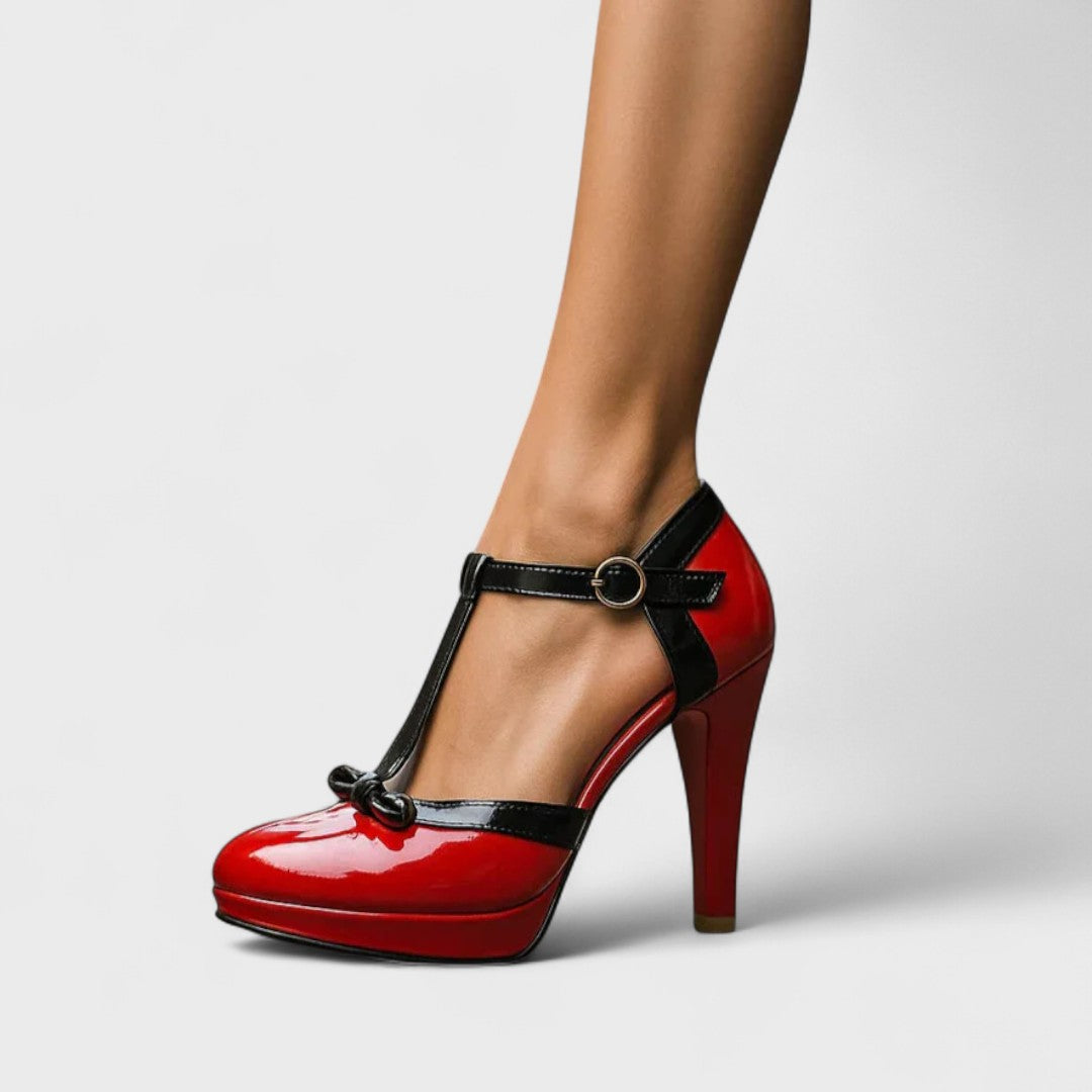 Red high-heeled shoe with black accents on a neutral background