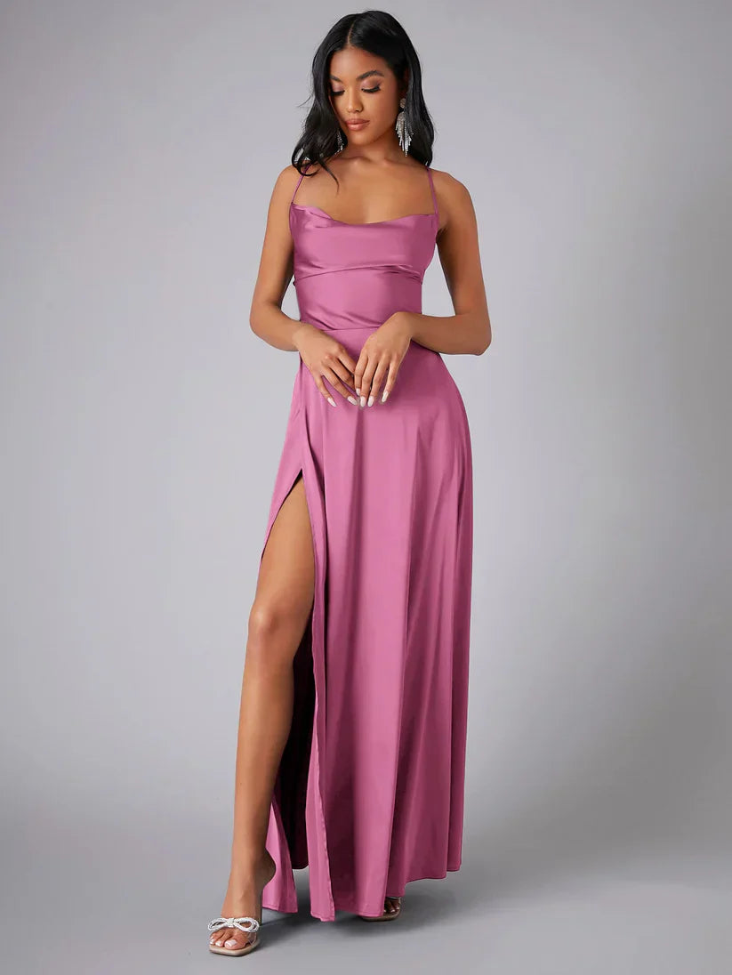 Woman wearing a pink strapless gown with a high slit on a gray background