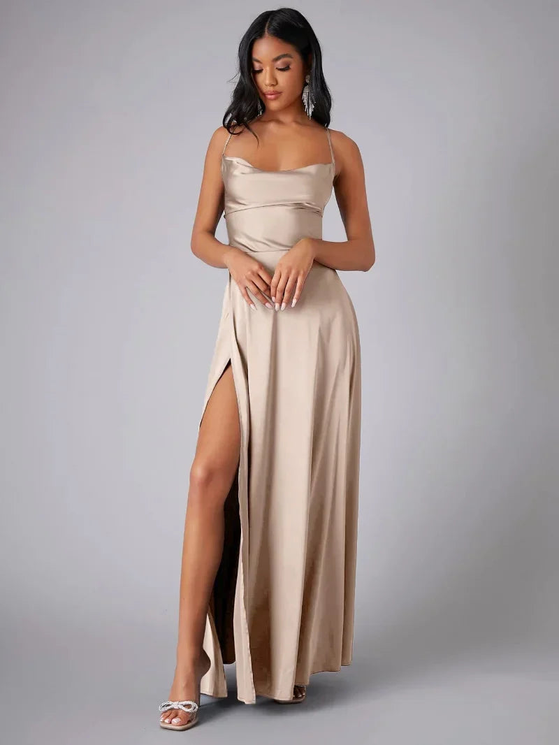 Woman wearing a beige strapless gown with a high slit on a gray background