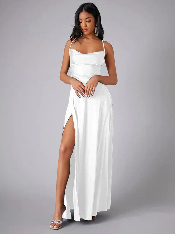 Woman wearing a white dress with a slit on a gray background