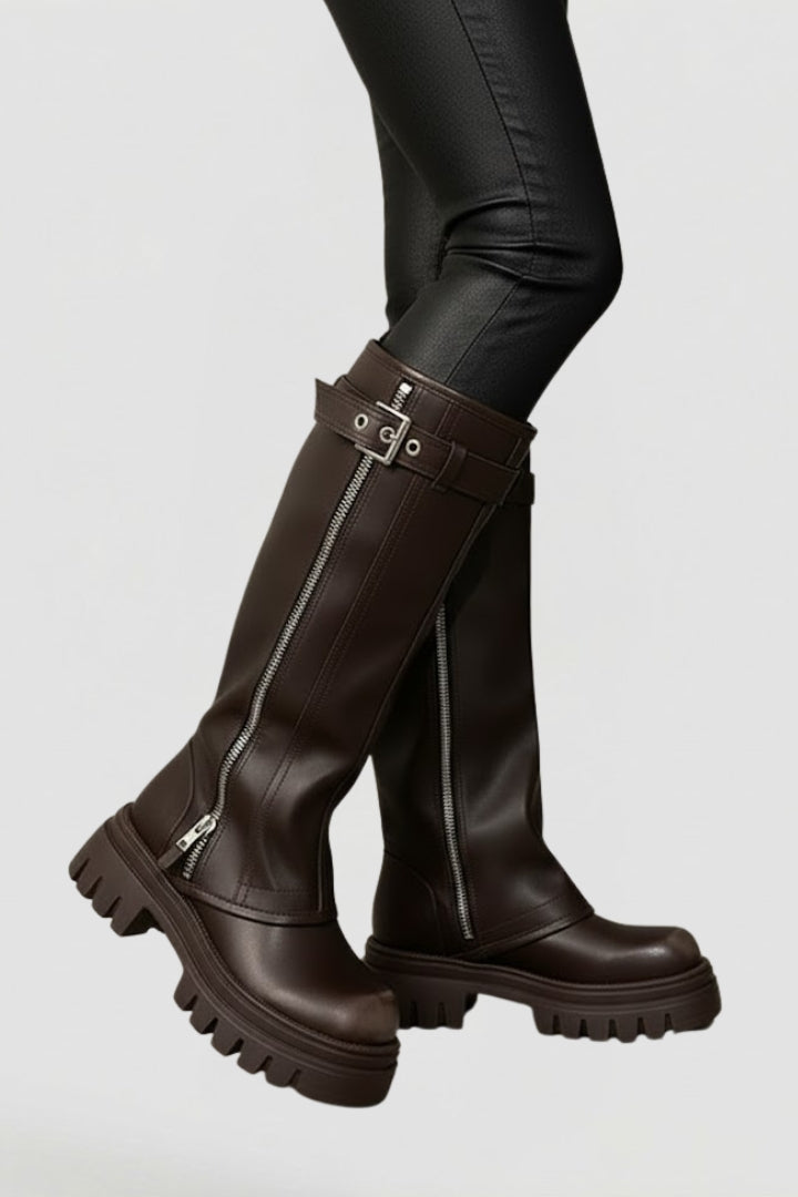 Brown knee-high boots with zippers on a white background