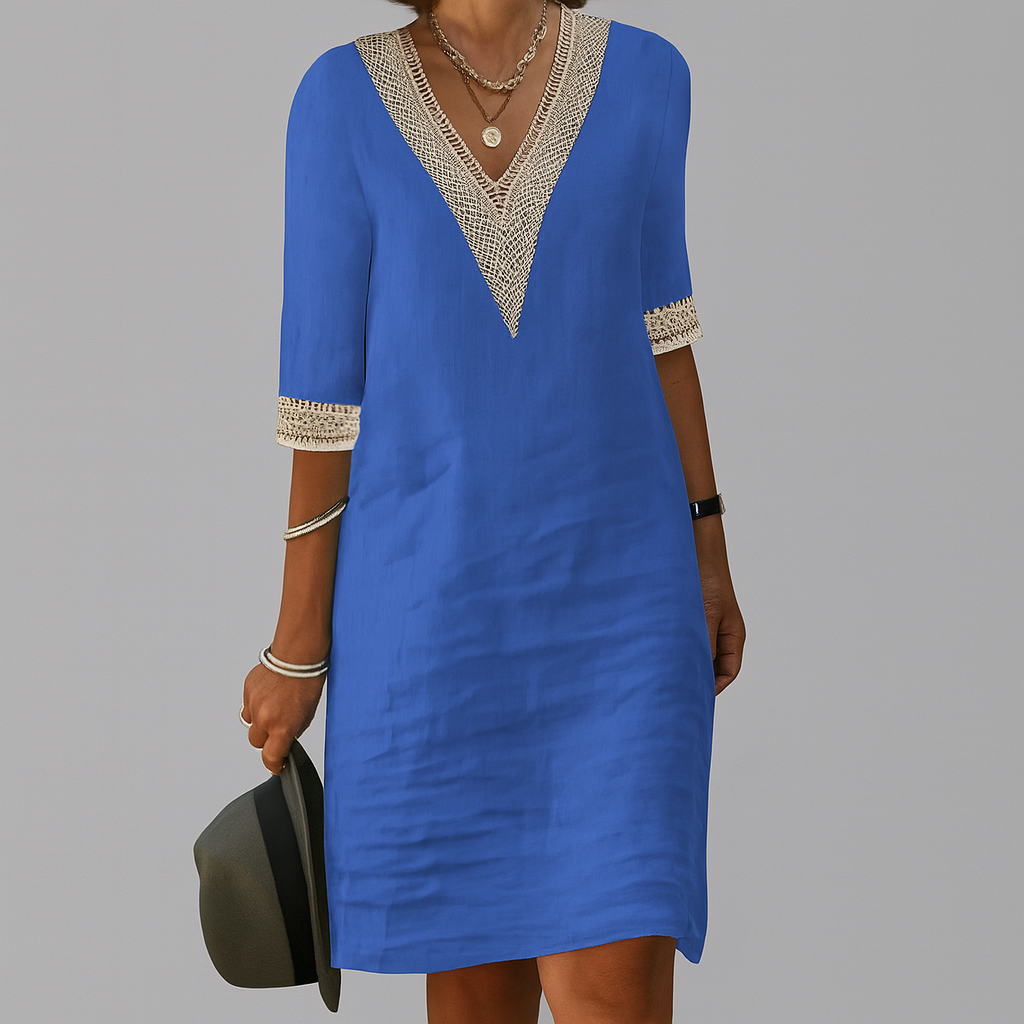 Blue dress with white lace details on a gray background