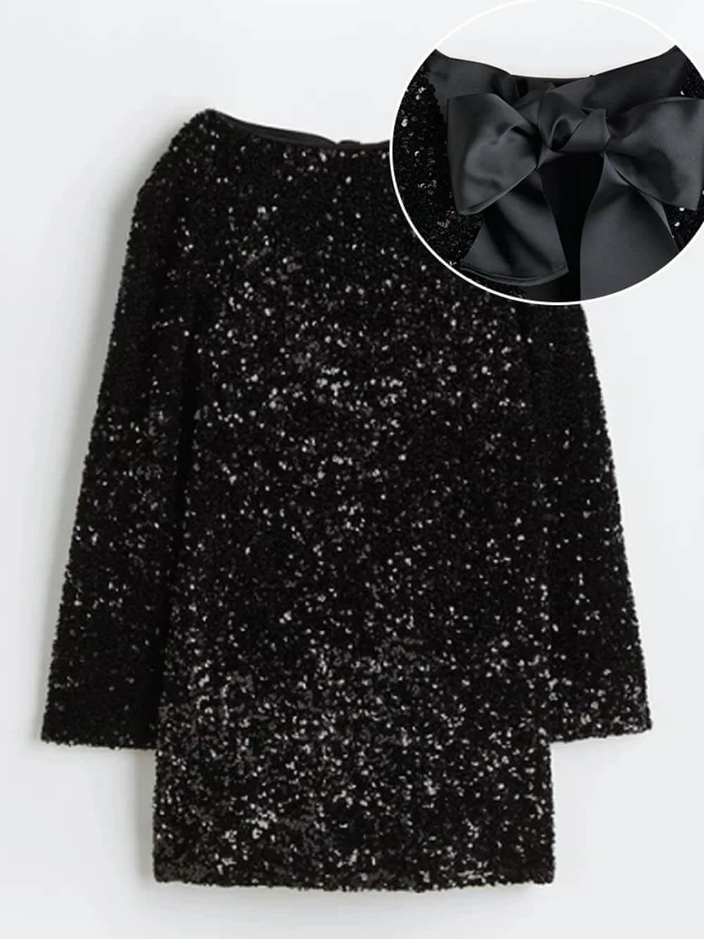Black glittery dress with a large bow detail on a white background