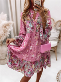 Woman wearing a pink floral dress holding a matching handbag indoors.