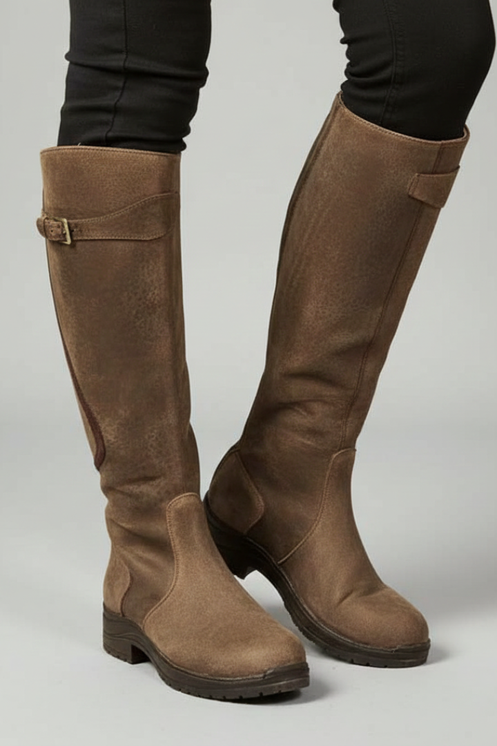 Brown knee-high boots on a plain background