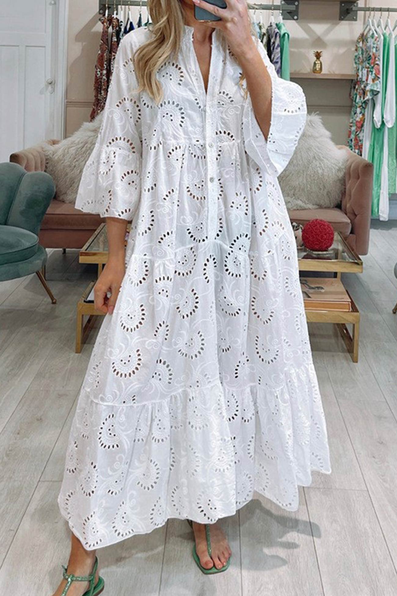 Woman wearing a white lace dress in a store setting