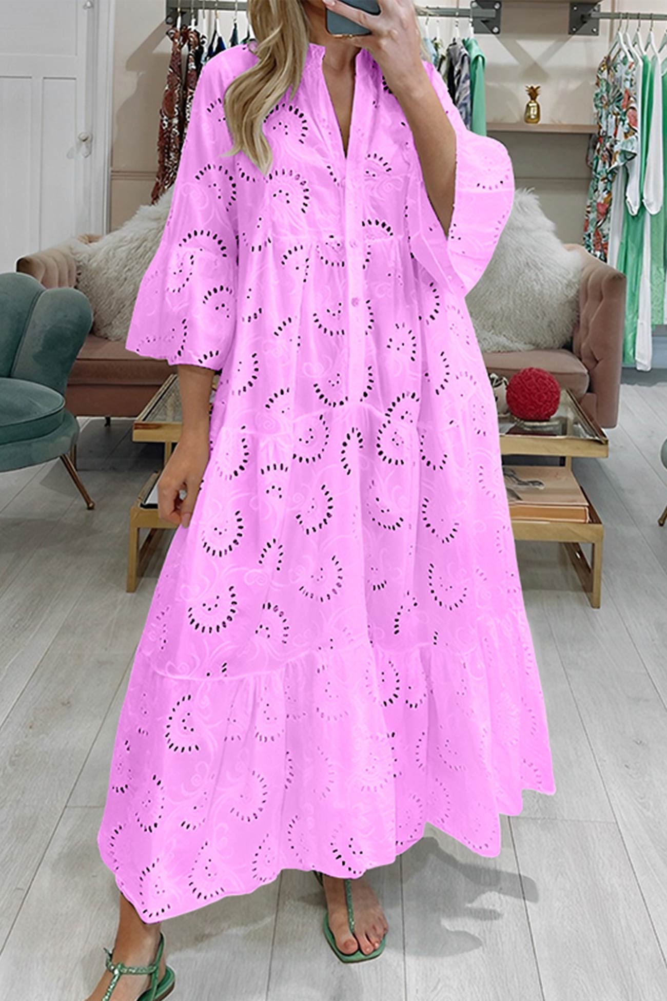 Person wearing a pink lace dress in a store setting
