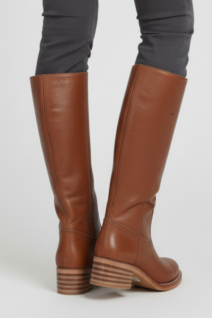 Brown knee-high boots on a white background