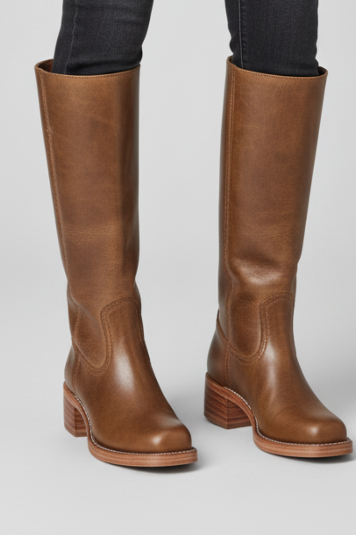 Brown knee-high boots on a light gray background