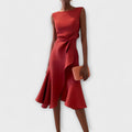 Red dress worn by a model on a white background