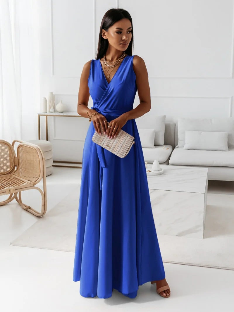 Woman in a blue dress holding a clutch in a modern living room.