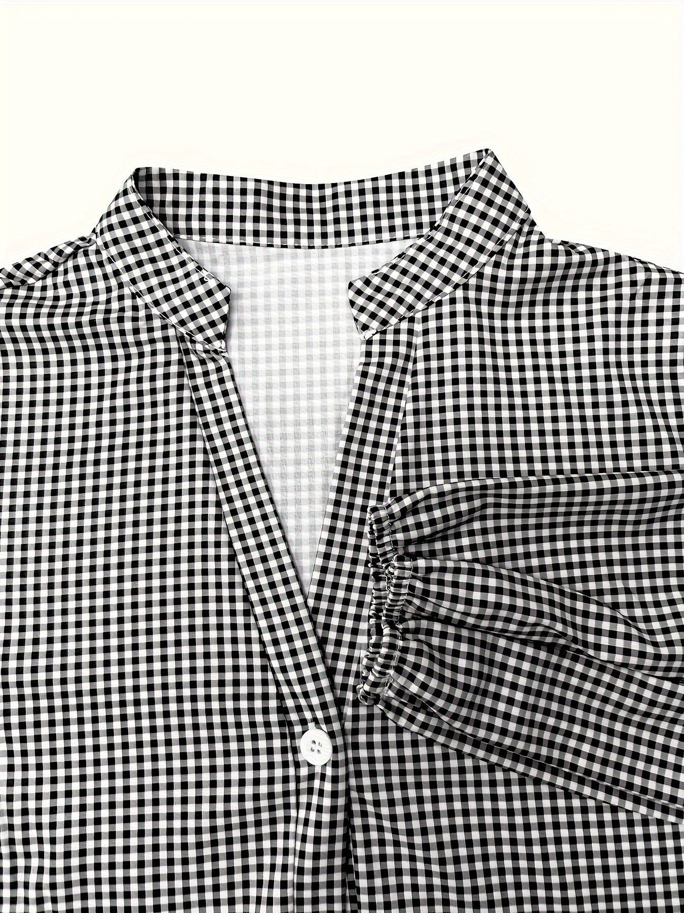Black and white checkered shirt with a collar on a white background