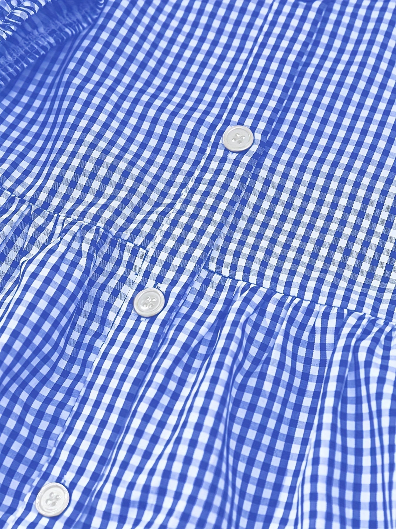 Close-up of a blue and white checkered shirt with buttons.