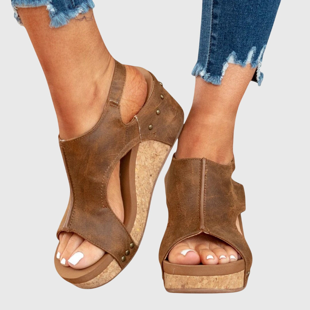 Brown open-toe wedge sandals on a neutral background