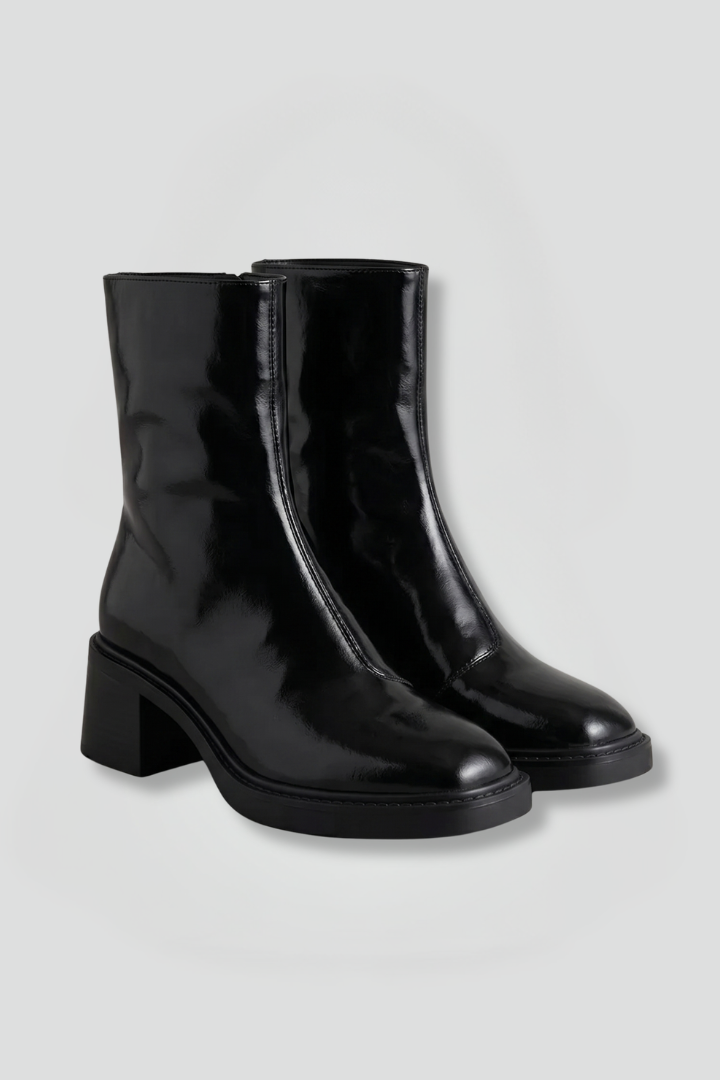 Pair of black leather Chelsea boots on a white background