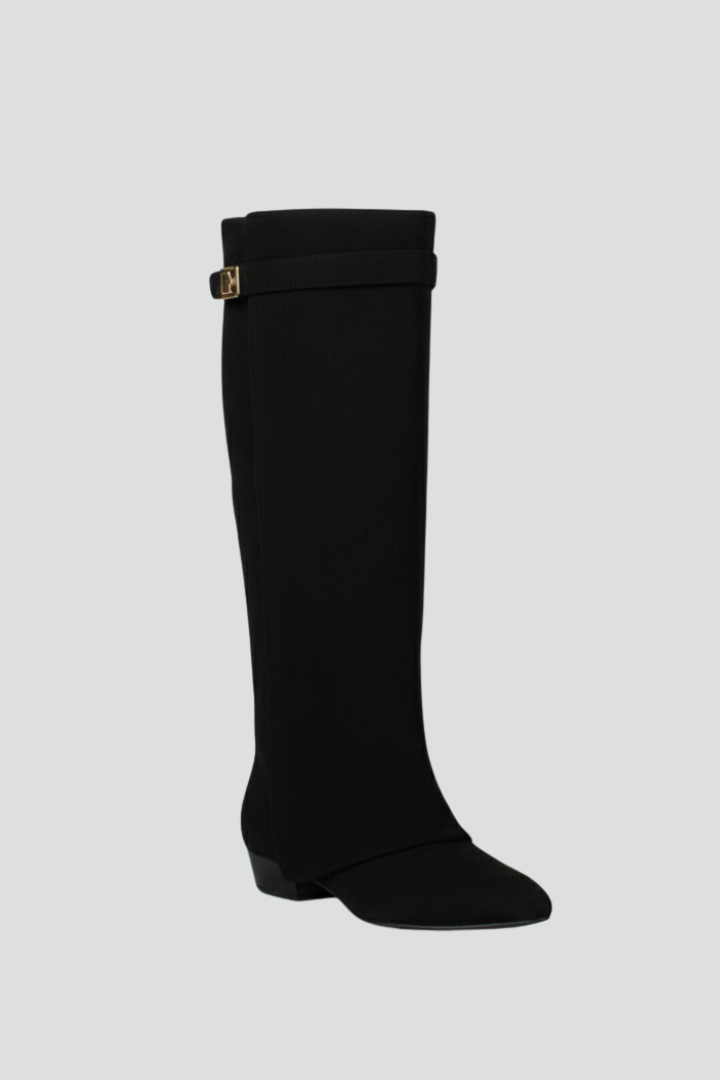 Black knee-high boot with a strap on a light gray background