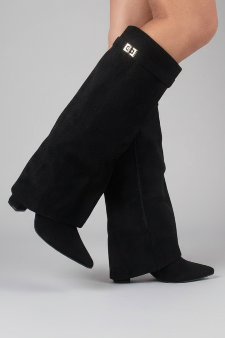 Black leg warmers worn by a person on a gray background