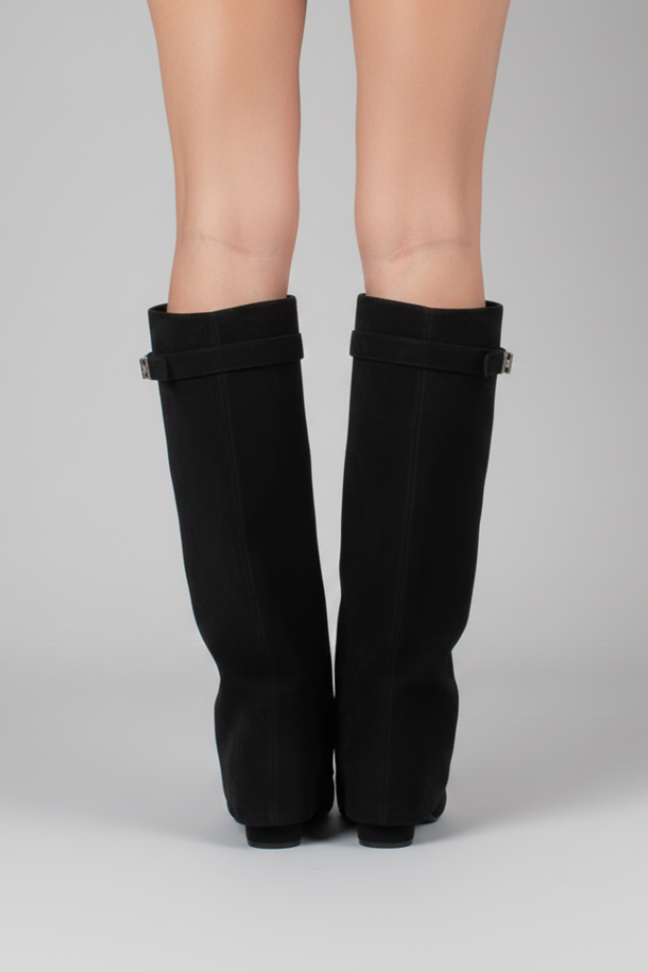 Black knee-high boots on a gray background