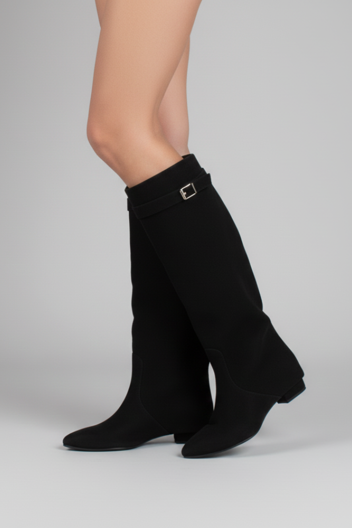 Black knee-high boots with a buckle on a gray background