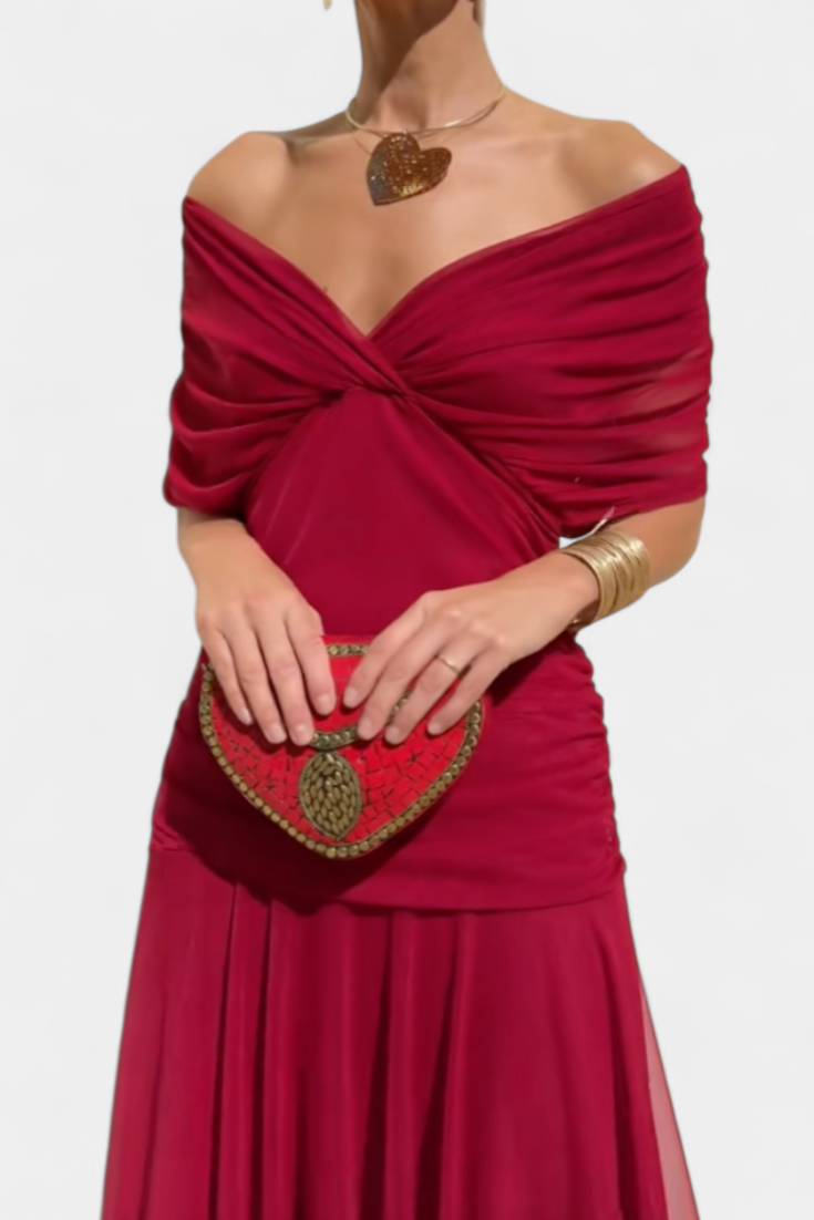 Red off-shoulder dress with a matching heart-shaped handbag on a white background