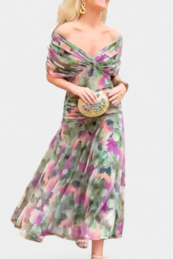 Woman wearing a colorful off-shoulder dress with a plain background