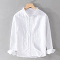 White shirt on a hanger against a gray background