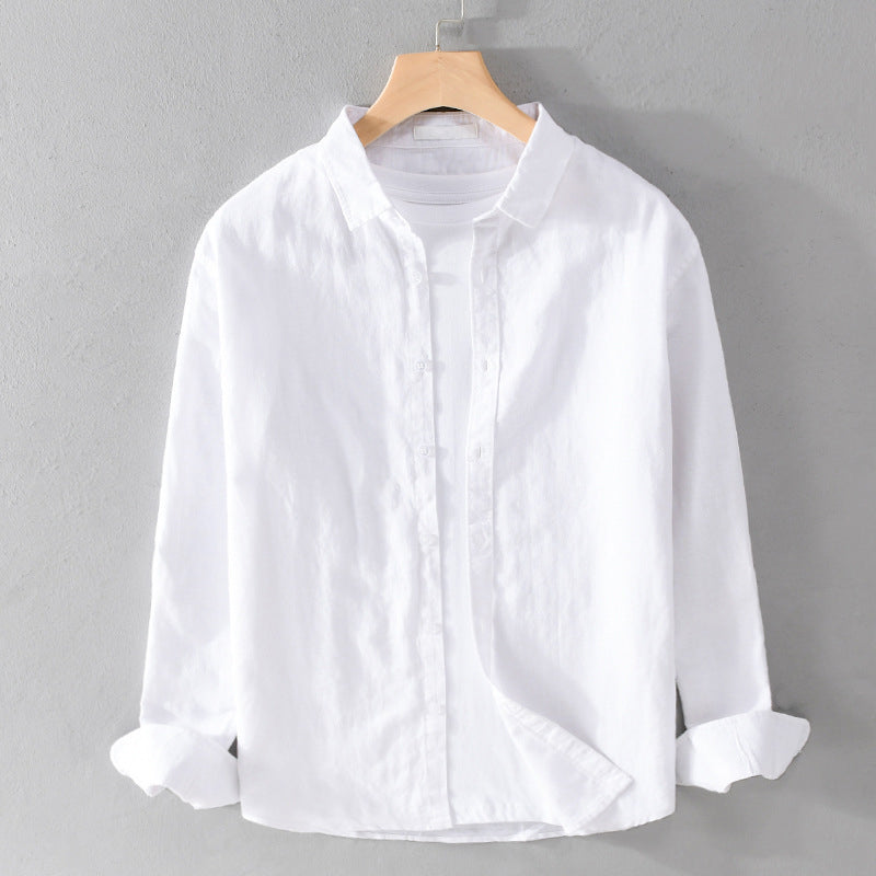 White shirt on a hanger against a gray background