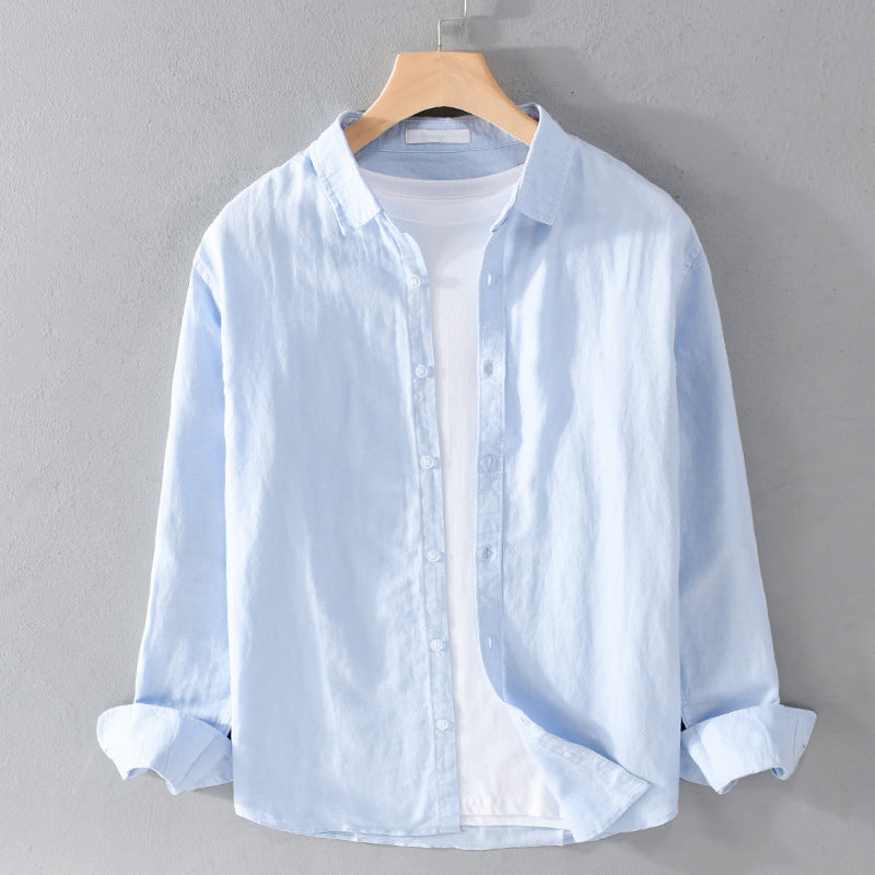 Light blue shirt on a hanger against a gray background