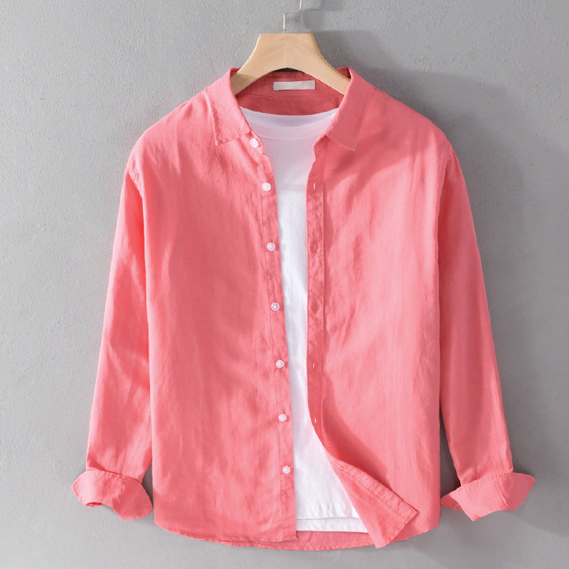 Pink button-up shirt on a hanger against a gray background