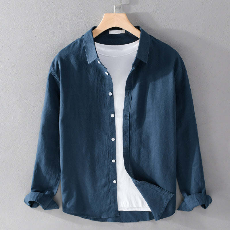 Blue shirt on a hanger against a gray background