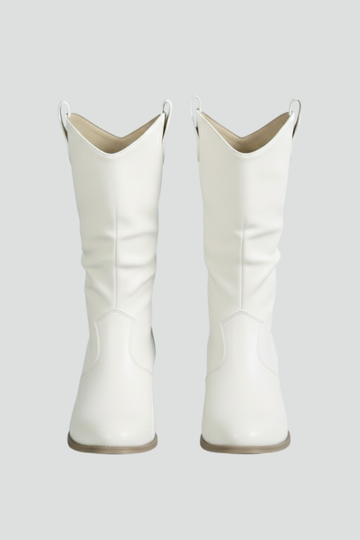 Pair of white cowboy boots on a light gray background