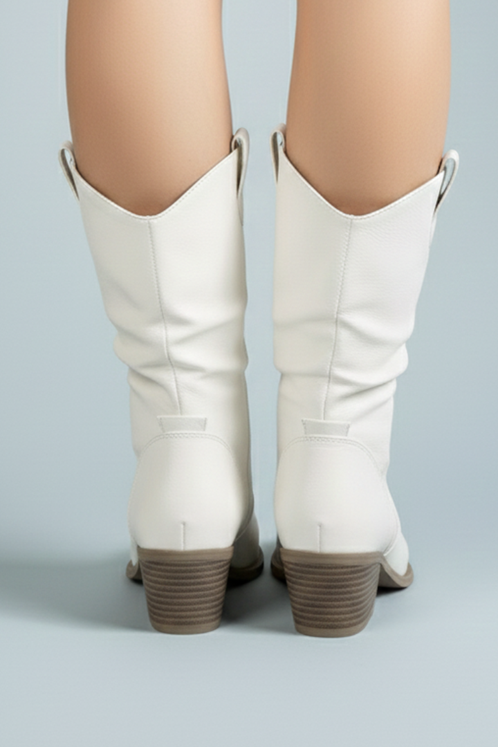 White knee-high boots with brown soles on a light gray background