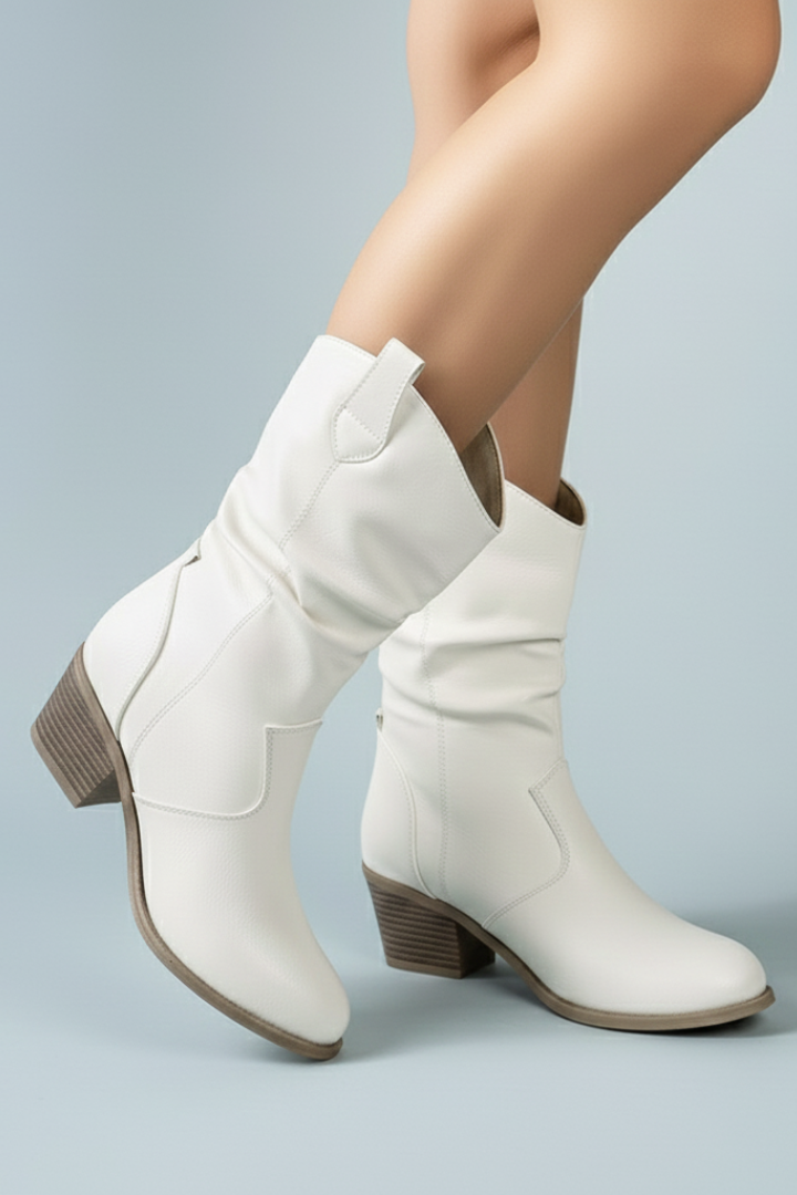 White knee-high boots on a light gray background
