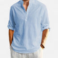 Light blue button-up shirt with rolled-up sleeves on a white background