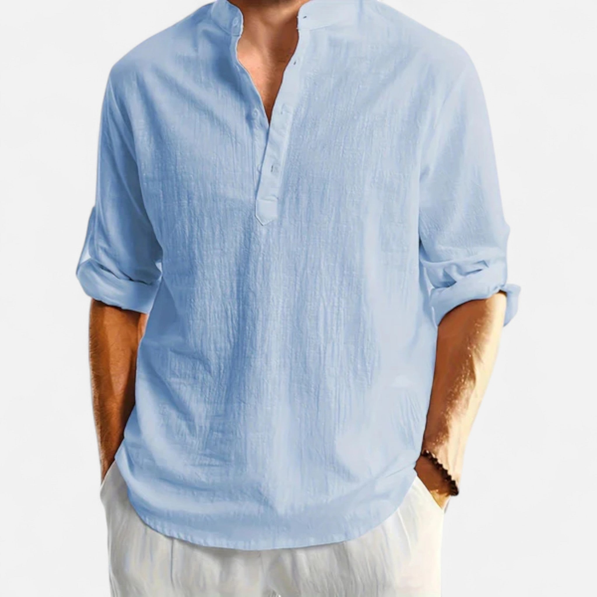 Light blue button-up shirt with rolled-up sleeves on a white background