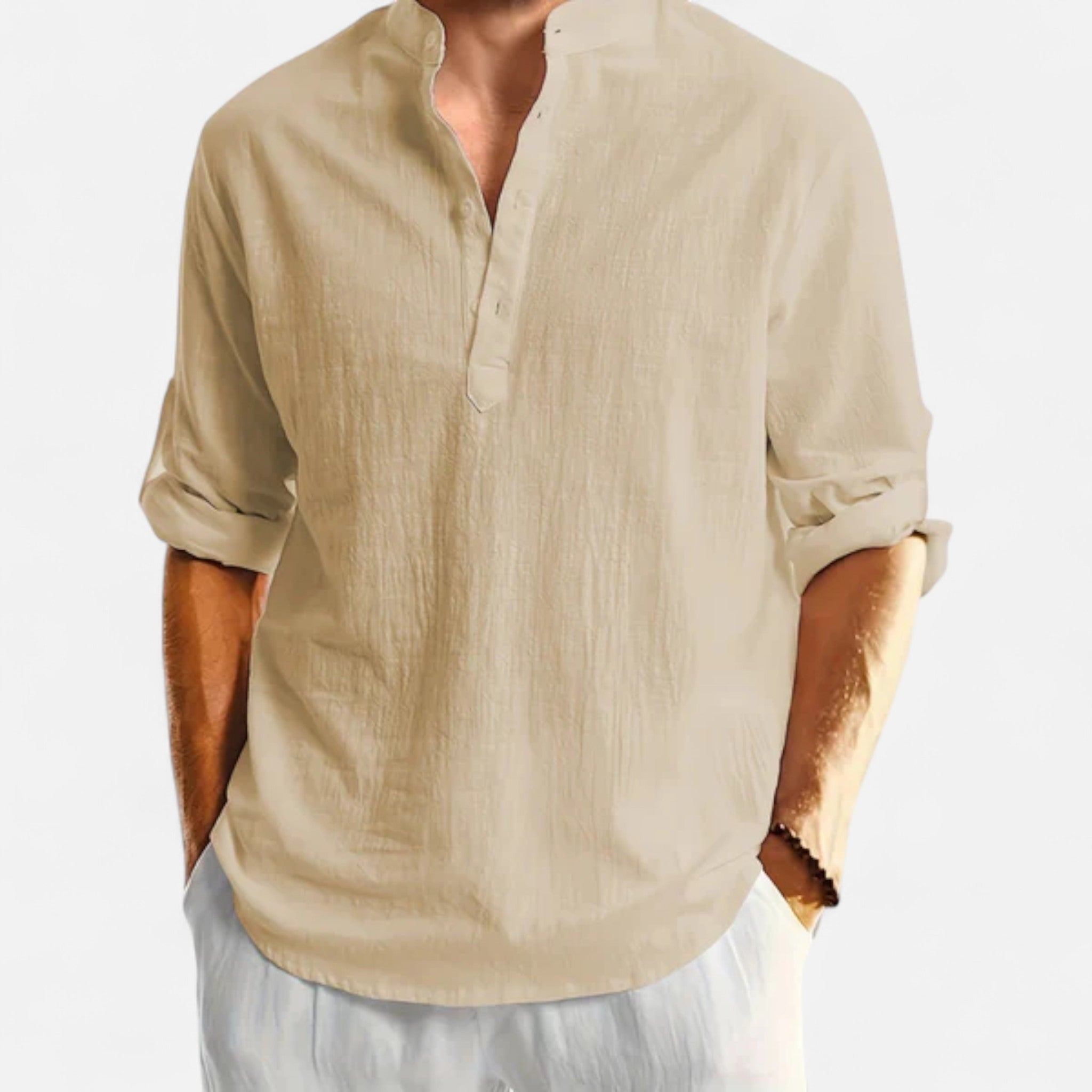 Beige shirt worn by a person on a white background
