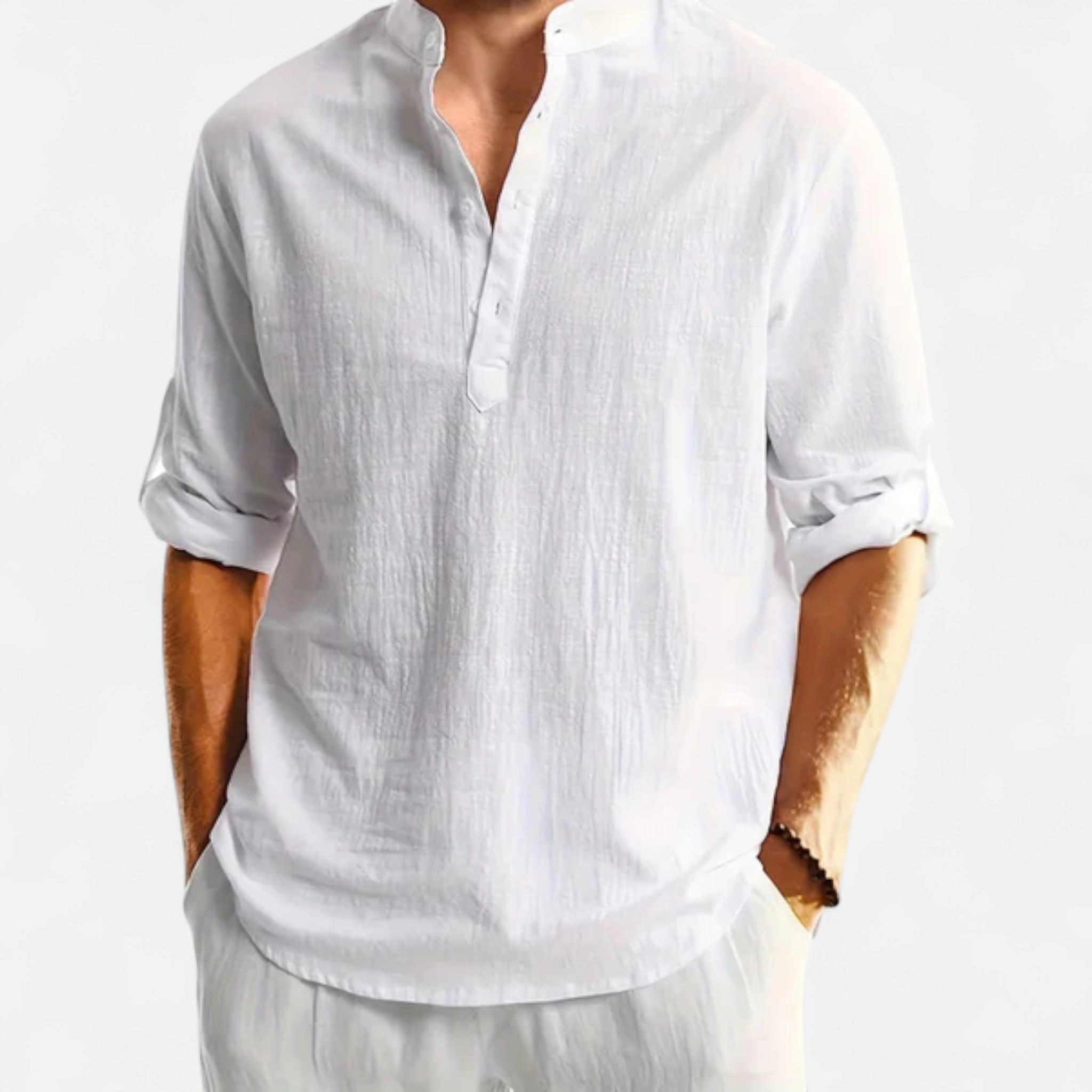 White linen shirt worn by a person on a white background