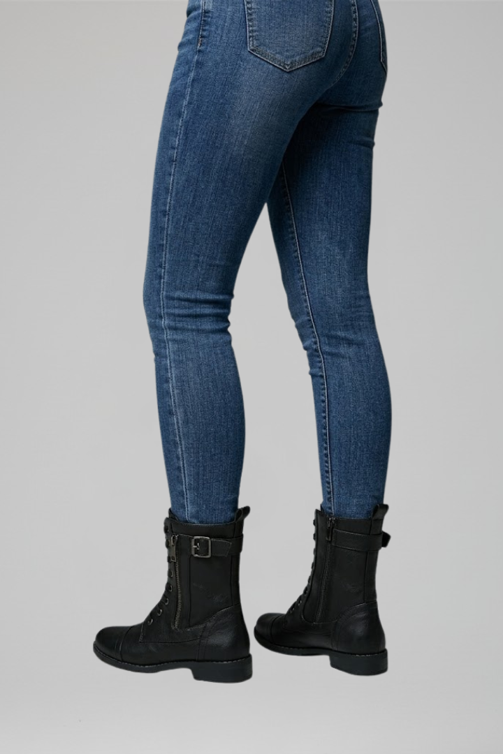 Blue jeans worn by a person on a gray background